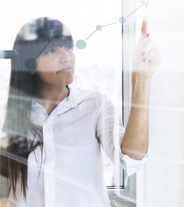 young businesswoman pointing finger increasing graph transparent glass